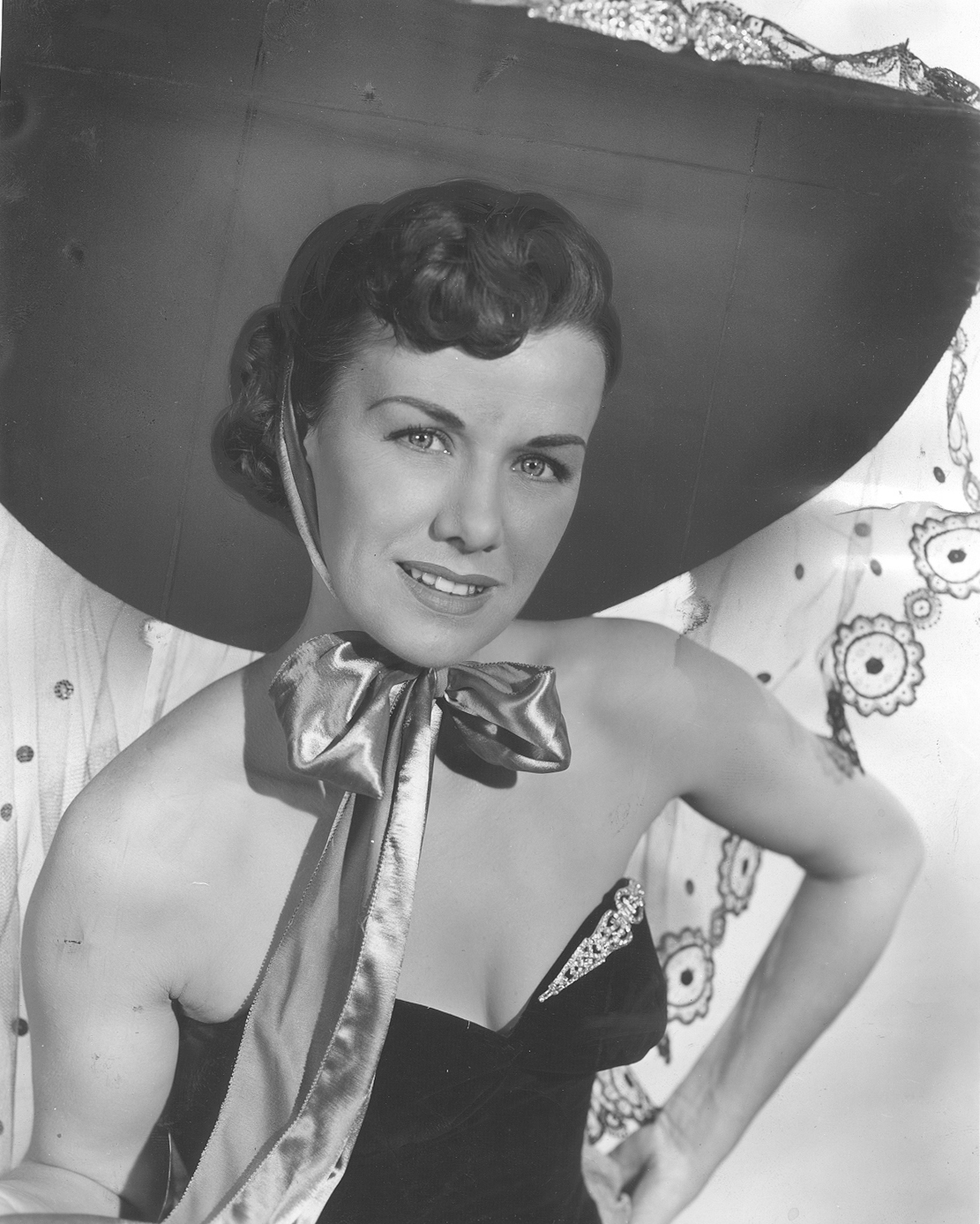 Jean Spangler in showgirl outfit with large hat and strapless gown