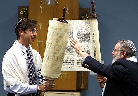 November 7, 2008: Dr. Joel Kushner, left, and Rabbi Richard N. Levy unroll the Yanov Torah during a ceremony at the Hebrew Union College-Jewish Institute of Religion near USC. The Torah survived the Holocaust by being cut into pieces, hidden during the war and reassembled afterward.