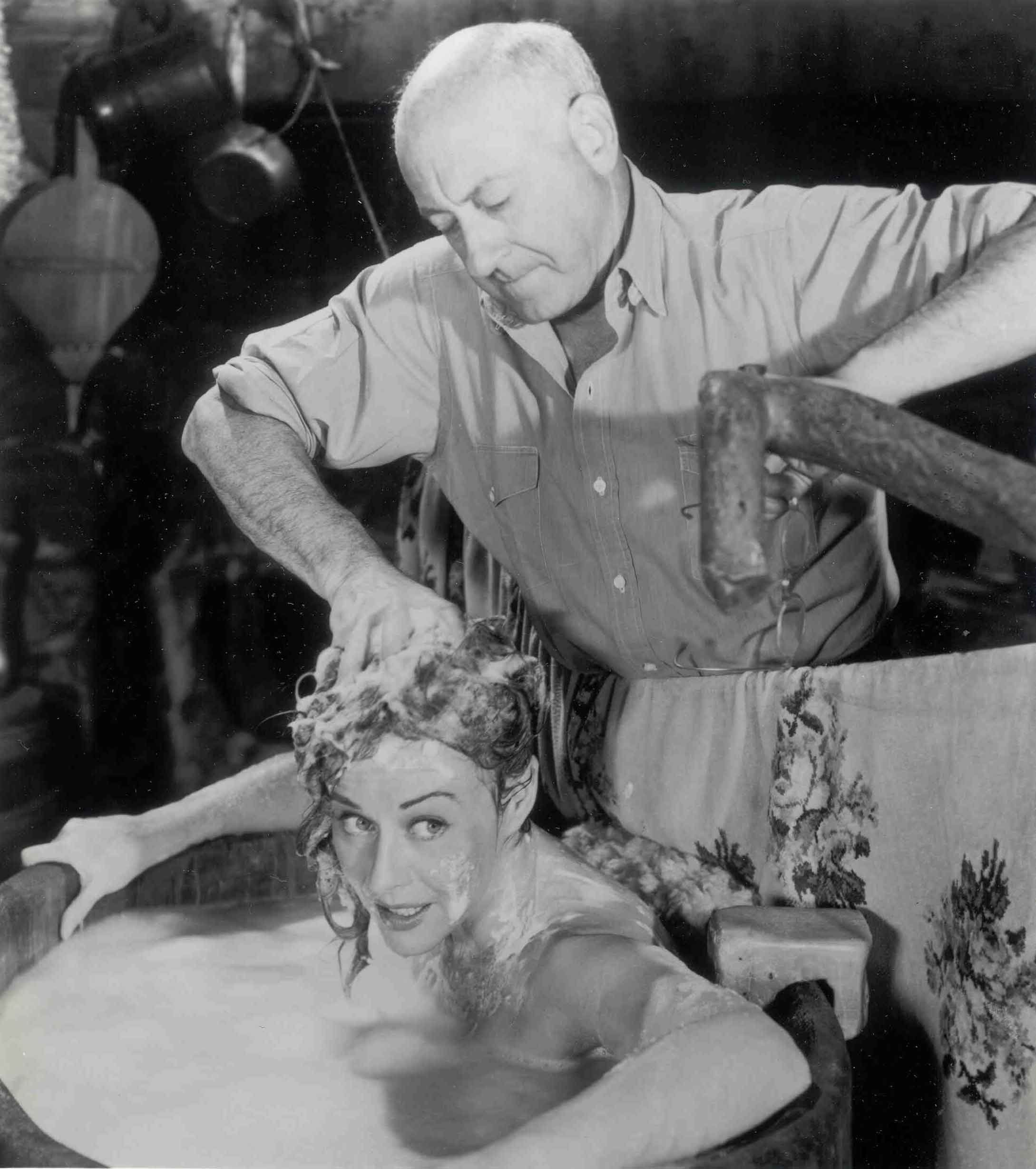 Paulette Goddard and De Mille in "The Unconquered." 