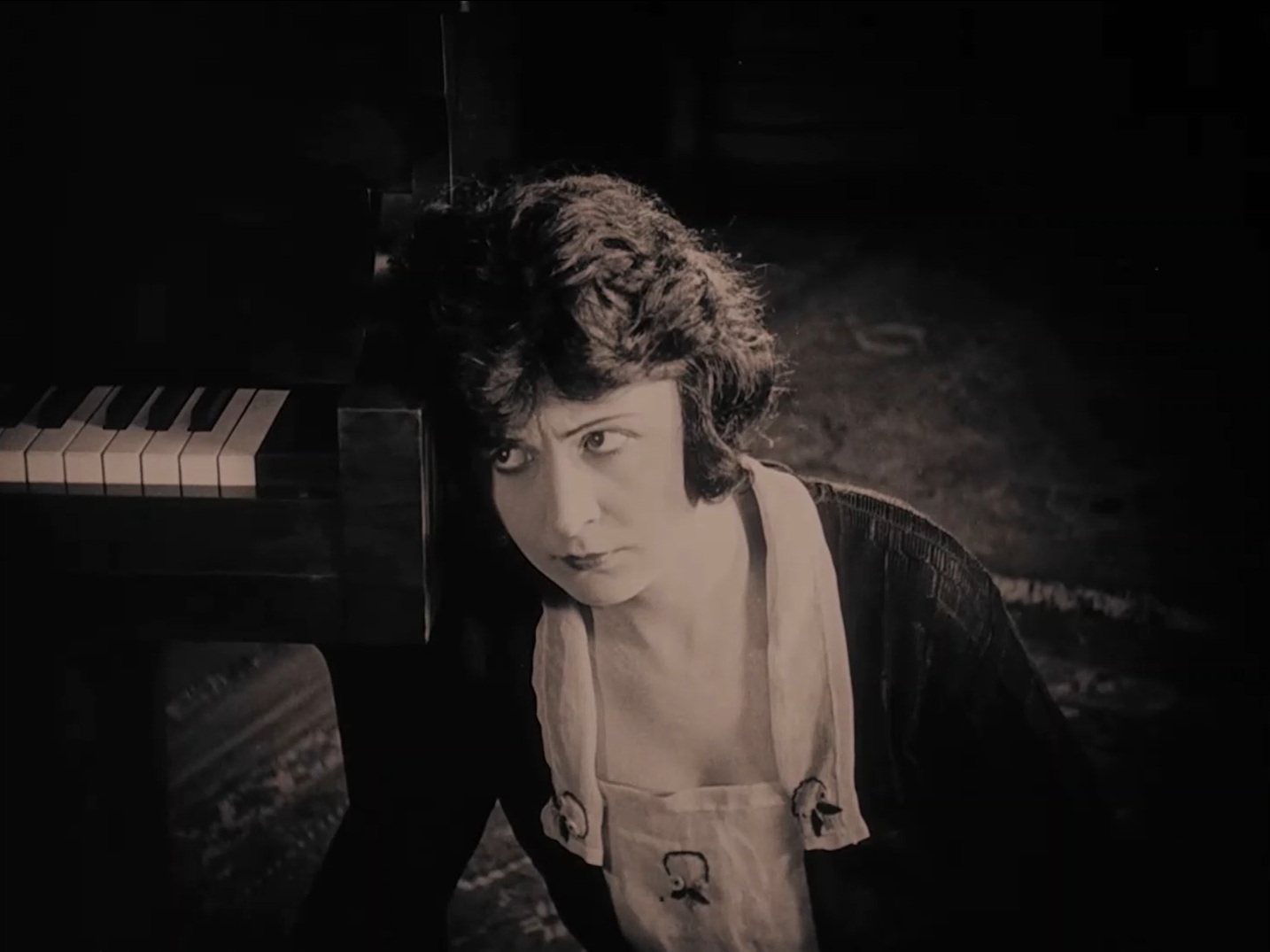 Ethel Gray Terry as Rose, leaning against the piano as Blizzard plays