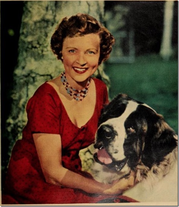 Betty White in a red dress with a St. Bernard