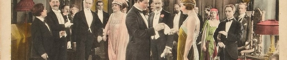 Lobby card, How Women Love, Men and women in stylish 1920s tuxedos and gowns standing in a ballroom.