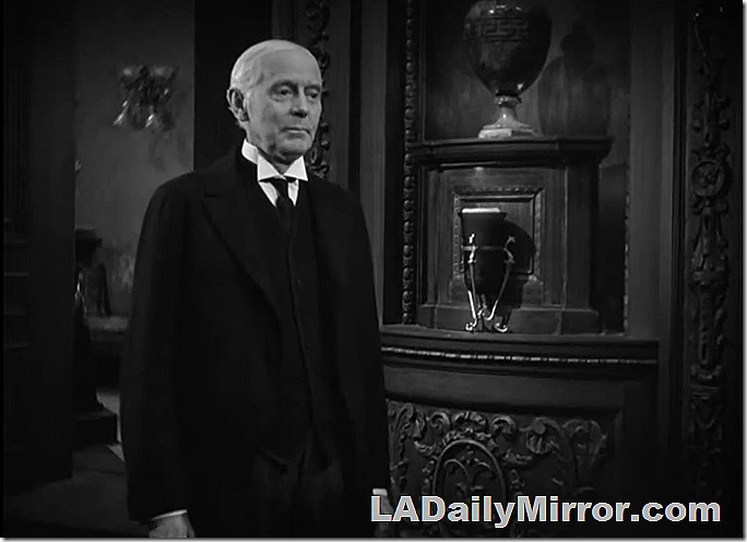 White-haired butler in a wing collar awaiting orders