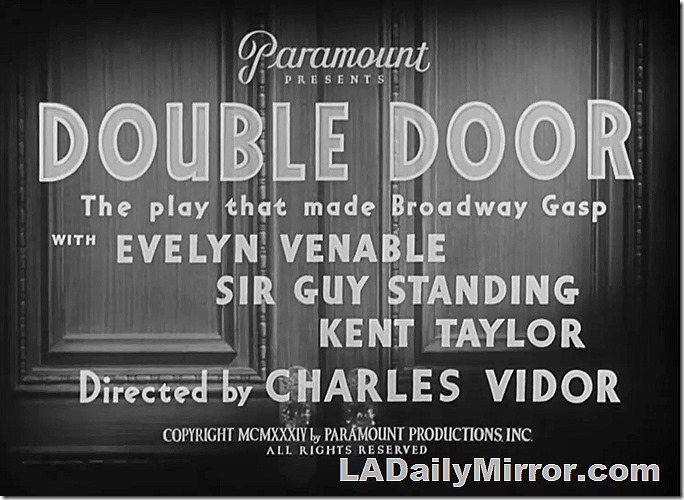 Main Title for Double Door with credits superimposed on a pair of doors. 