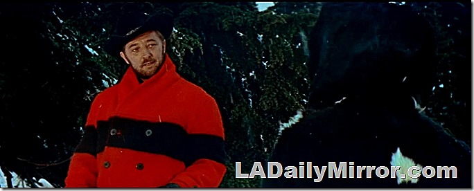 April 22, 2022, Mystery Photo. Man outdoors in cowboy hat and bright red coat