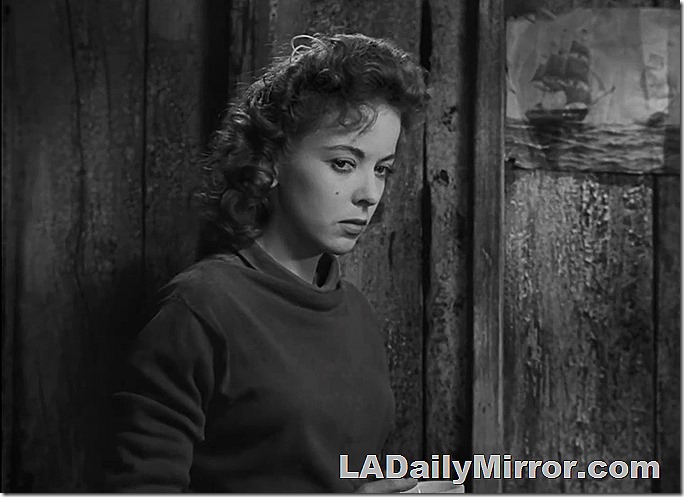 Woman in a mock turtleneck casts a sidelong glance