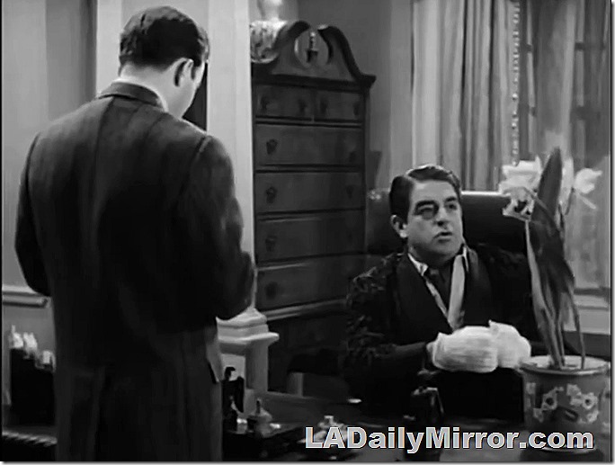 An elegantly dressed man in a dressing gown, seated at a desk, examines a mystery plant. Also Back of the Head Guy.