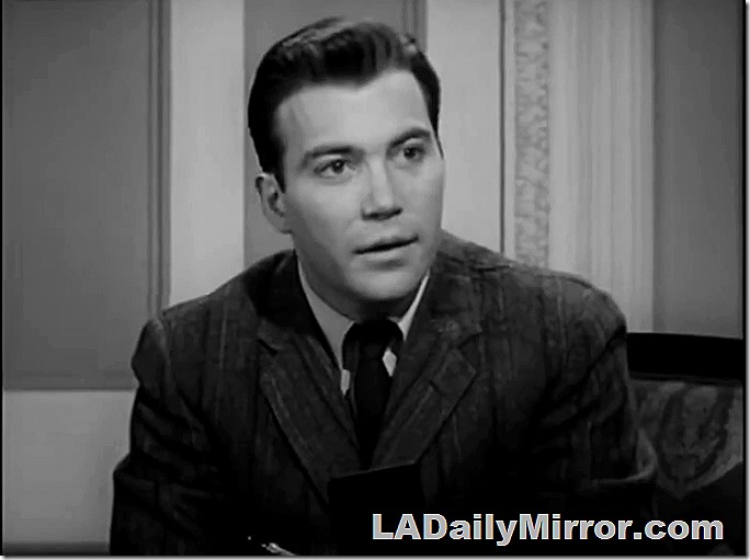 Man in suit coat and tie. Looks earnest. 