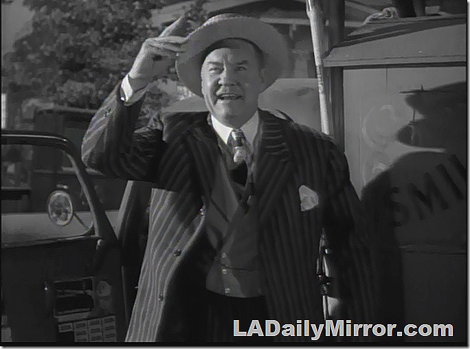 Man in straw hat with pinstriped suit
