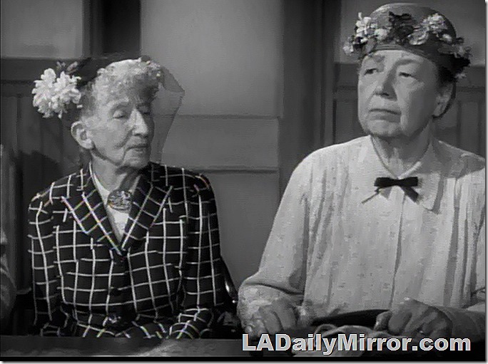 Dour-faced women in hats. They do not approve of such goings-on!