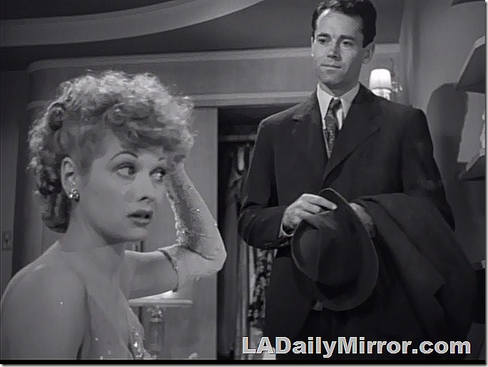 Mystery showgirl arranges her hair as mysterious admirer watches