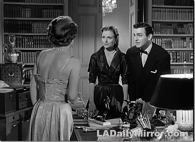 Elegantly dressed man and woman in a library