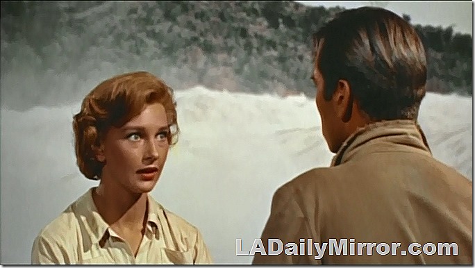 Redheaded woman against a raging river. With Back of the Head Guy