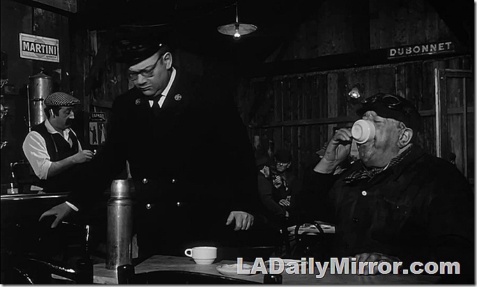 Man drinking from coffee cup, which obscures his face. Well, it *is* Tricky Tuesday