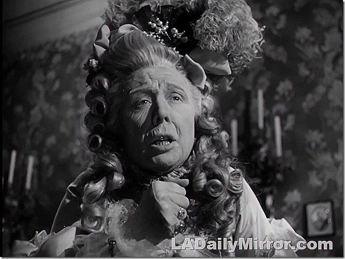 A regal, elderly woman, elegantly costumed