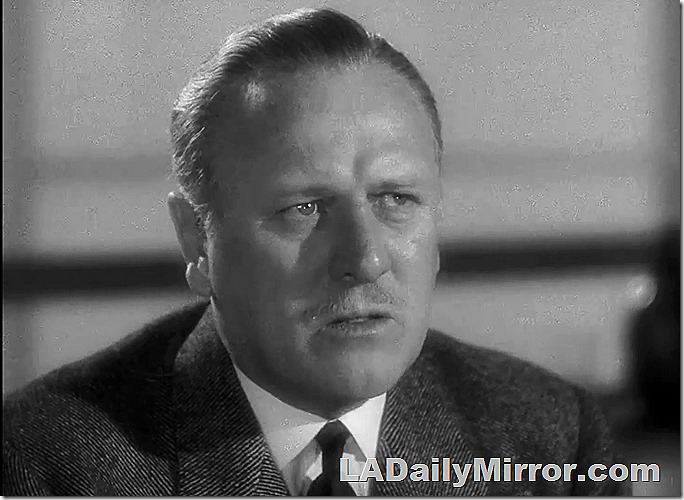 Man in coat and tie with neatly trimmed mustache