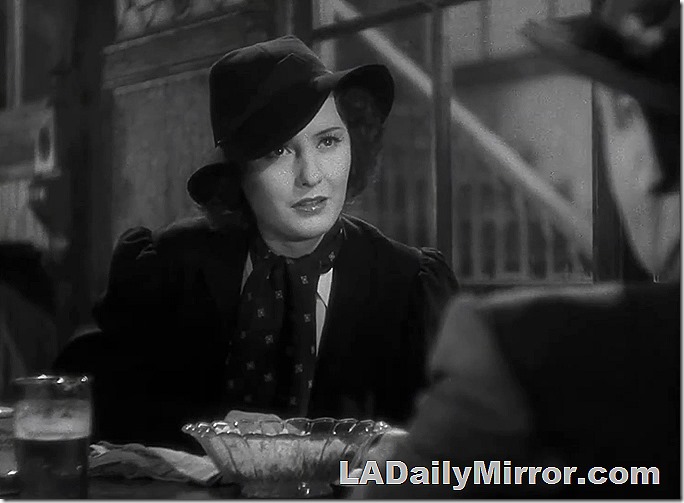 Mystery woman in wide brimmed hat, coat and scarf. 