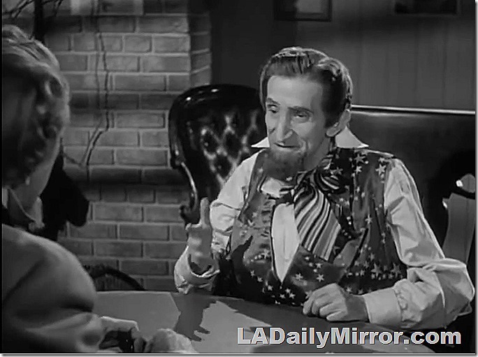 Man in a vest and false beard plays cards Man in a vest and false beard plays cards