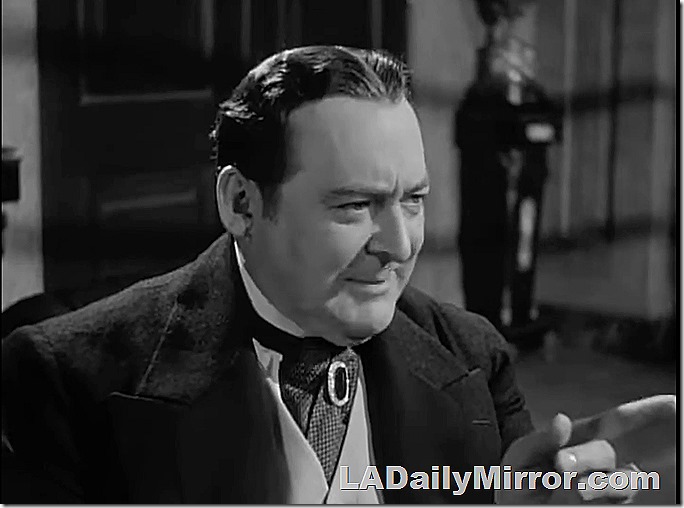 Elegantly dress man, hair parted in the middle. Wearing a vest and a cravat and caot with wide lapels. Elegantly dress man, hair parted in the middle. Wearing a vest and a cravat and caot with wide lapels.