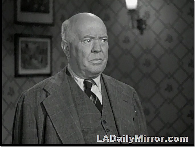 Our mystery fellow is bald, in a suit coat and matching vest. He is scowling and does not approve of such goings-on. 