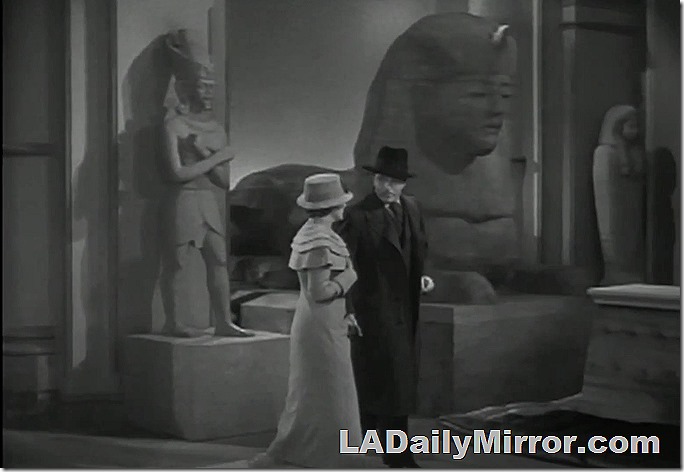 Couple walking in a museum near Egyptian statuary