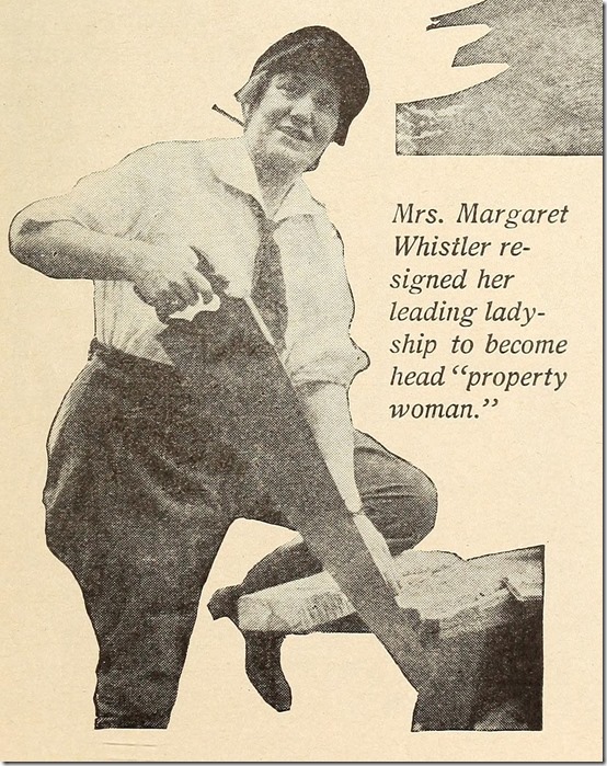 Margaret Whistler, wearing a tie and jodhpurs, saws a piece of wood. Margaret Whistler, wearing a tie and jodhpurs, saws a piece of wood.