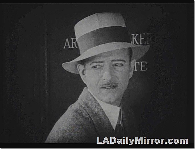 Man in hat, coat and tie. Very slight mustache