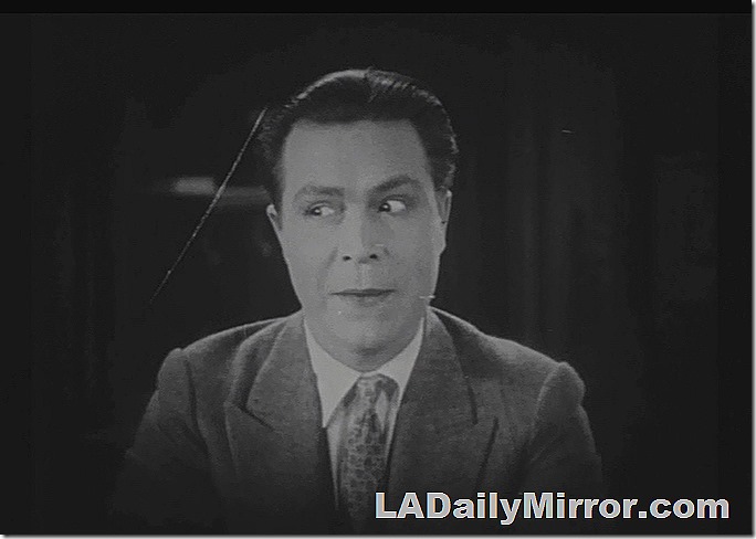 Man with dark hair, in suitcoat and tie, looking off to his left
