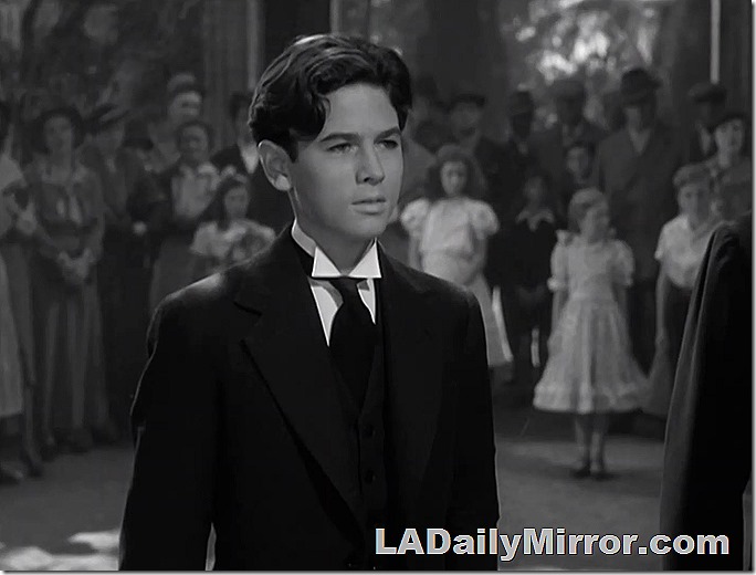 Young man in formal dress with wing collar. 
