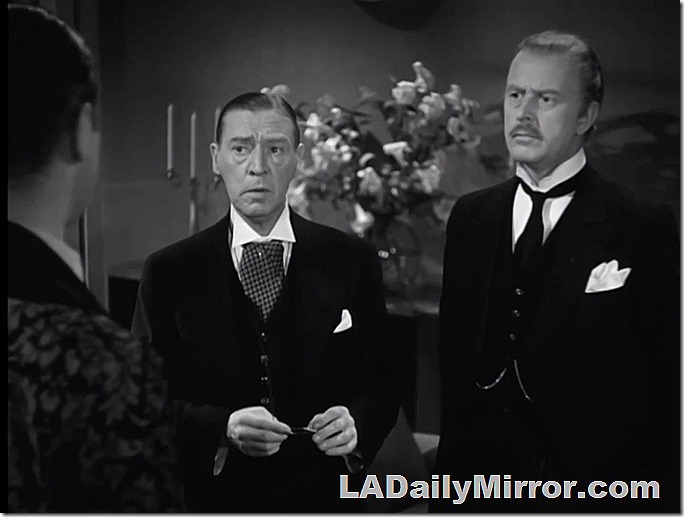 Two men in formal dress, with wing collars. 