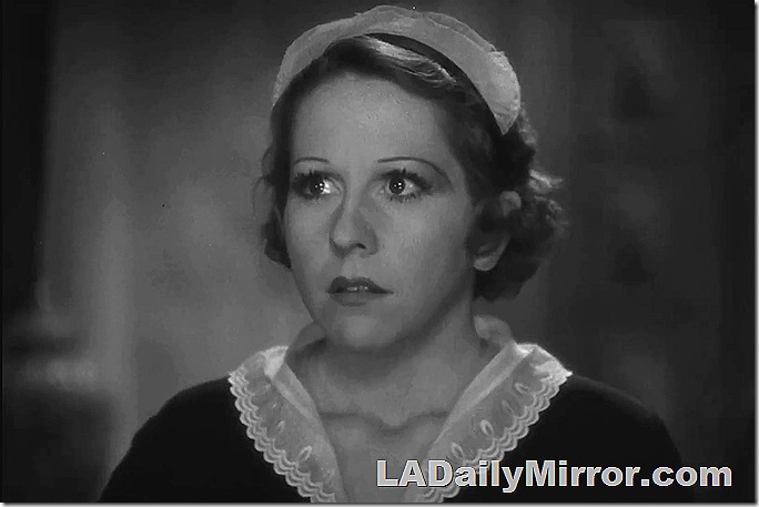 Pretty woman, short dark hair, in maid's outfit. 