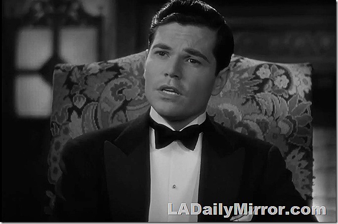 Another man sitting in a chair, wearing a tuxedo. He's wearing the tuxedo, not the chair. I mean the chair isn't wearing the tuxedo, the man is. Nor is the man wearing the chair. 