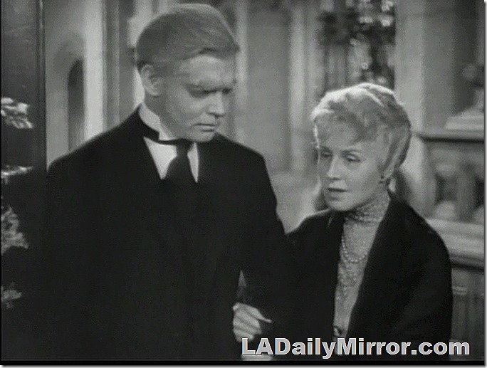 An old couple. He's in a batwing collar and tie, she wears a shawl. An old couple. He's in a batwing collar and tie, she wears a shawl.