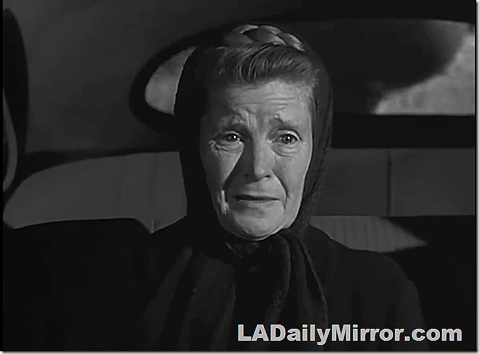 Woman with wrinkled face. A scarf around her head. 