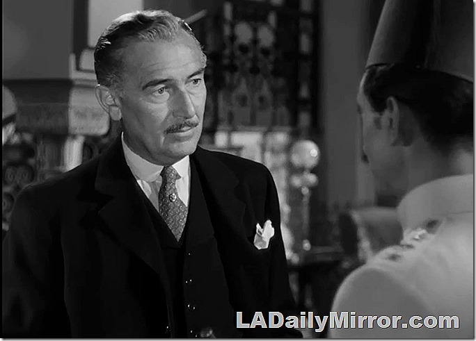 Man in three-piece suit with neatly trimmed mustache (the man, not the suit), also Back of the Head Guy