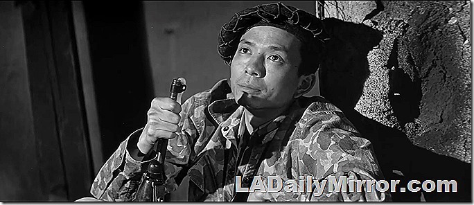 Man in camouflage fatigues with rifle. 