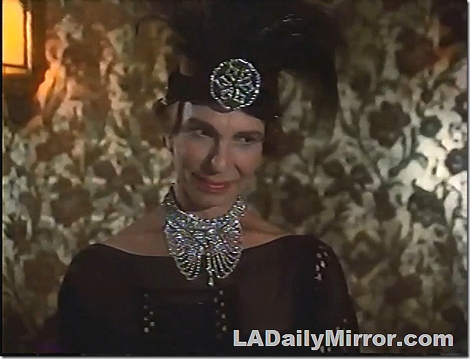 Woman with massive jewelry at her neck and forehead. 