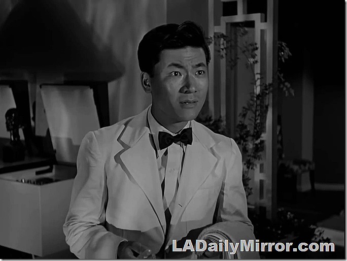 Man in white dinner jacket and bow tie.
