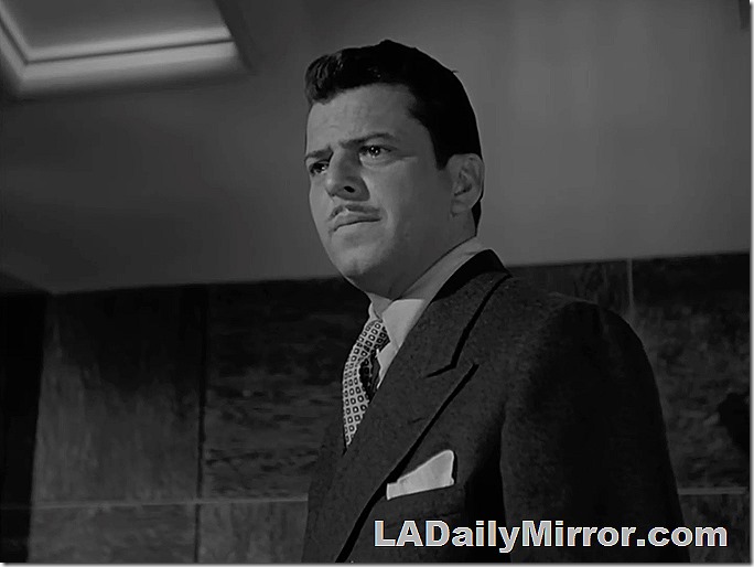 Man in double-breasted suit, tie, with pocket square 