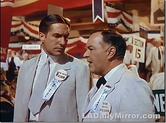 Two dapper men wearing campaign buttons. That fellow on the left sure looks familiar. The hair throws me off, though. 