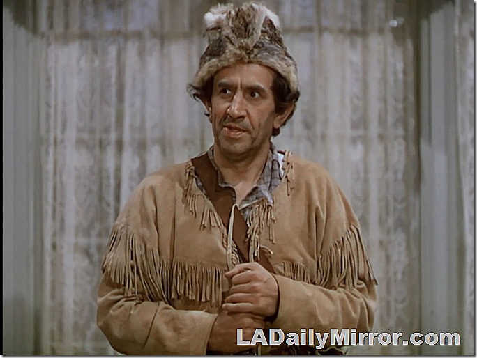 Frontiersman in fringe outfit with recently deceased critter on his head. 