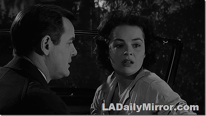 Man and woman in sports car. She is upset. 