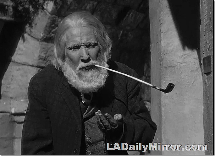 Ragged old man with a white beard and a long pipe. 