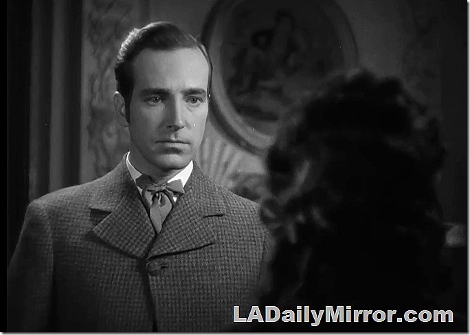 Man with neatly combed hair, in a coat and cravat.