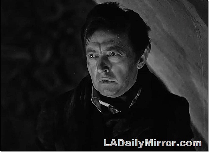 An astonished, disheveled man with stark lighting. 