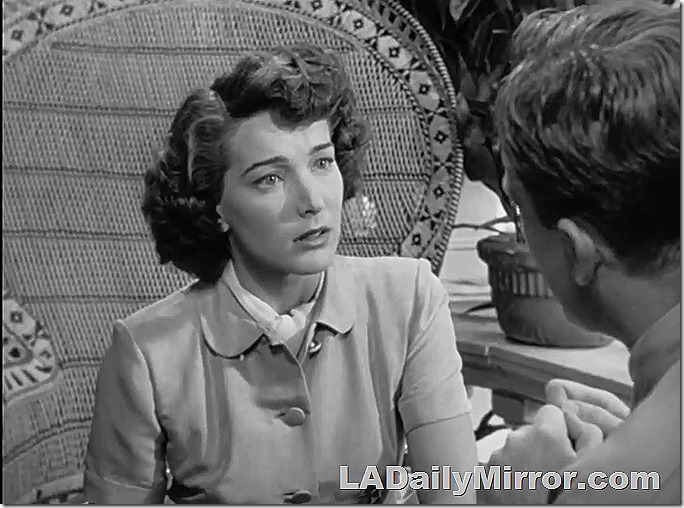Elegant woman in a rattan chair with a large back