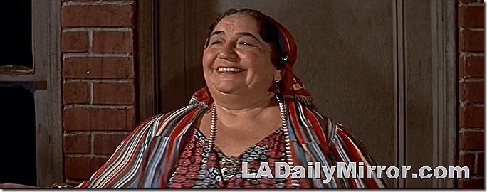 Woman smiling, in colorful garb