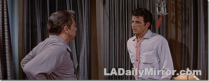 Man in pink shirt and loose tie. 