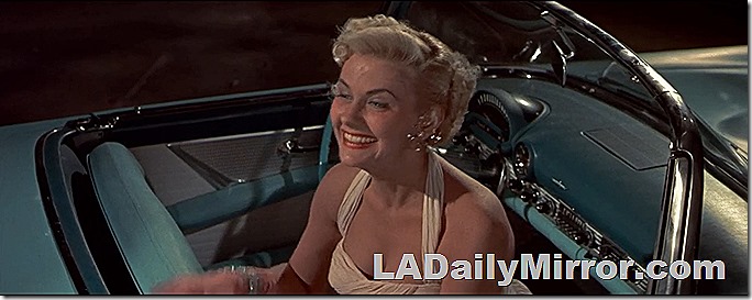 Mystery woman in sleeveless dress in mysterious convertible. 