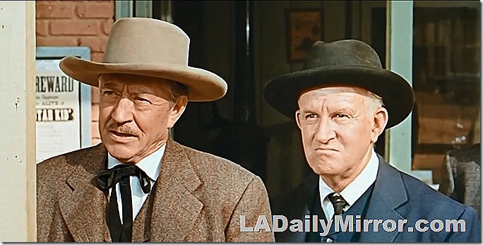 Men in western hats and coats. They look like they mean business. 